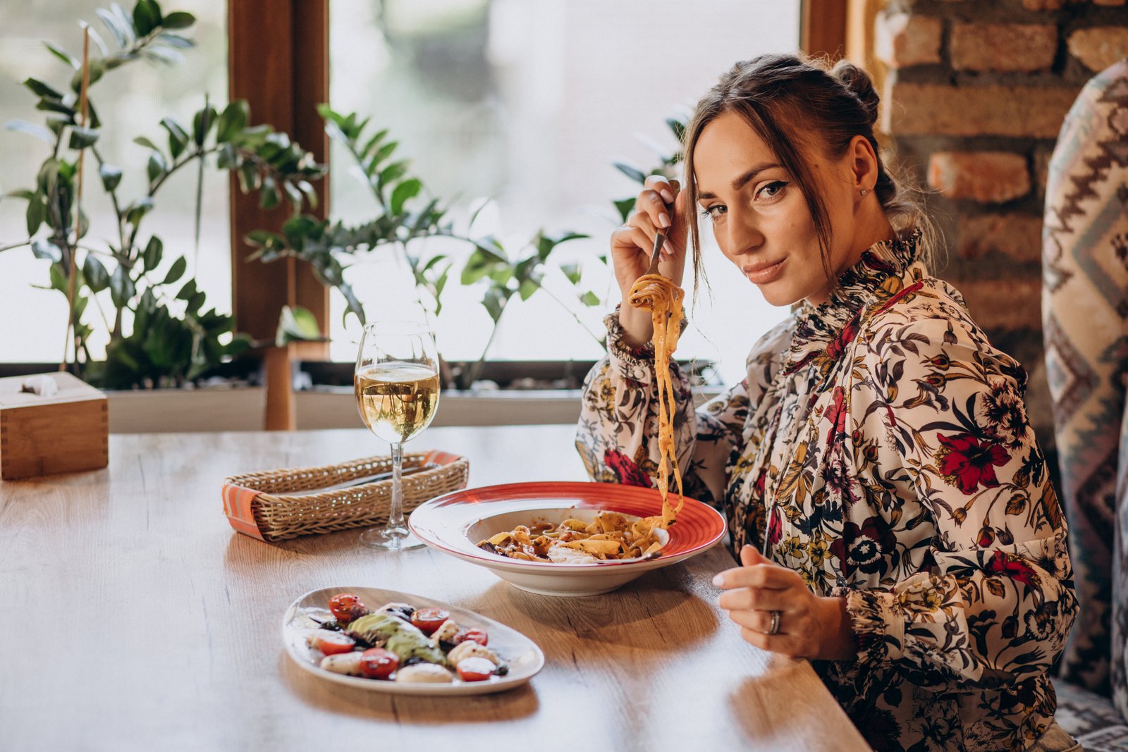 Woman eating pasta in an italian restaurant